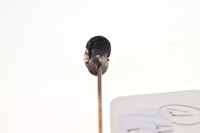 Lot 64 - A carved black onyx bust stick pin