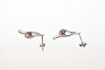 Lot 47 - 9ct white gold garnet and diamond cluster pendant and earrings