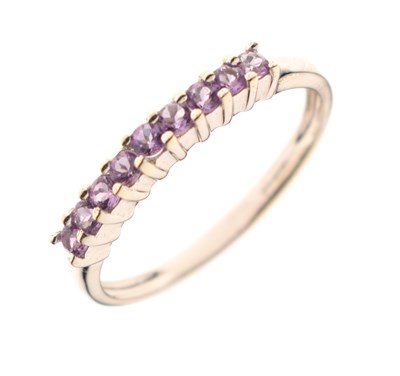 Lot 52 - 9ct white gold nine-stone amethyst half hoop ring