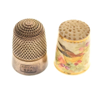 Lot 292 - Silver thimble in Mauchline ware case, together with a painted porcelain thimble