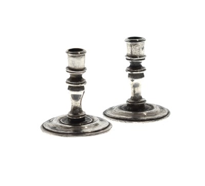 Lot 110 - Pair of unmarked white-metal miniature candlesticks