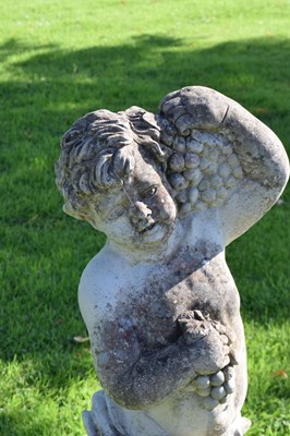 Lot 726 - Composite stone garden statue of a cherub holding grapes