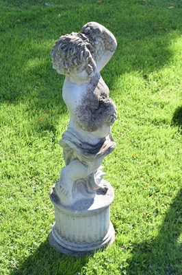 Lot 726 - Composite stone garden statue of a cherub holding grapes