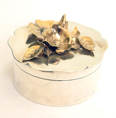 Lot 274 - Elizabeth II circular silver box the lid decorated with gilt flowers