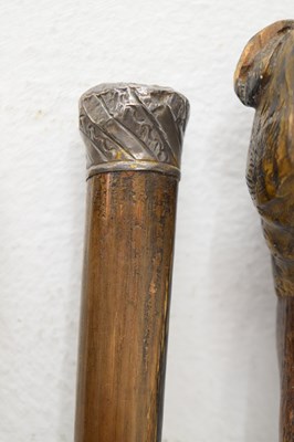 Lot 320 - Edwardian silver capped walking cane, together with four walking sticks