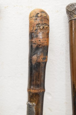 Lot 320 - Edwardian silver capped walking cane, together with four walking sticks