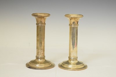 Lot 232 - Pair of George V silver columnular candlesticks