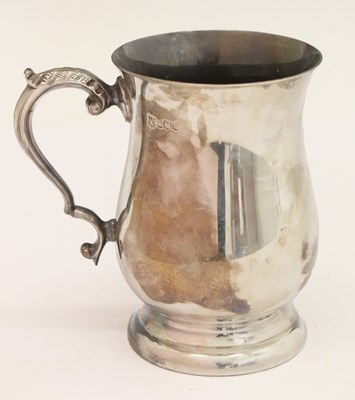 Lot 256 - Elizabeth II silver mug of bellied footed form with scroll handle