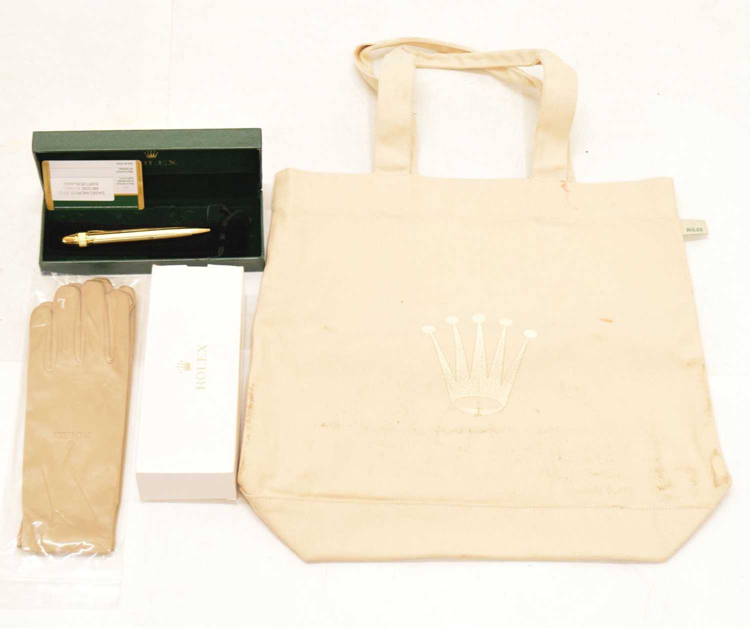 Lot 162 - Rolex - Gilt metal retractable ballpoint pen, pair of dealers gloved and tote bag