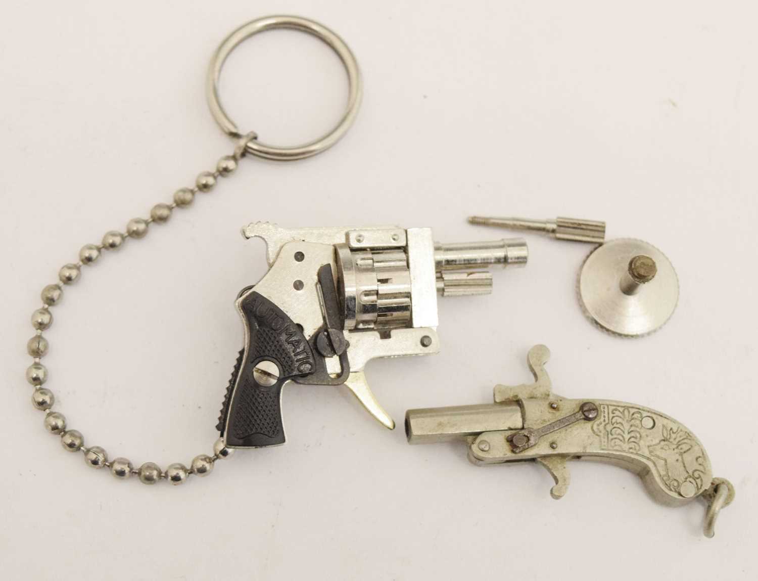 Lot 411 - Berloque type miniature pistol, together
