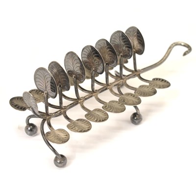 Lot 246 - Victorian silver toast rack having seven branches with lily pad terminals