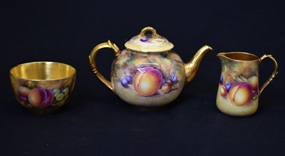 Lot 418 - Royal Worcester - Fruit decorated teapot, milk jug and sugar basin