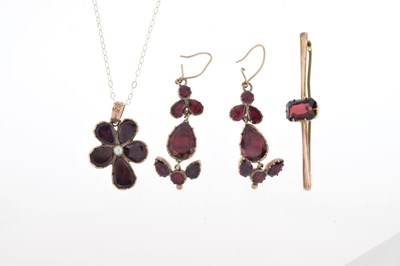 Lot 43 - Foil-backed garnet and seed pearl pendant in the form of a flower head