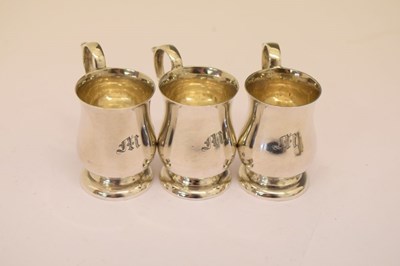 Lot 86 - Cased set of six Edward VII silver tot measures in the form of miniature baluster mugs