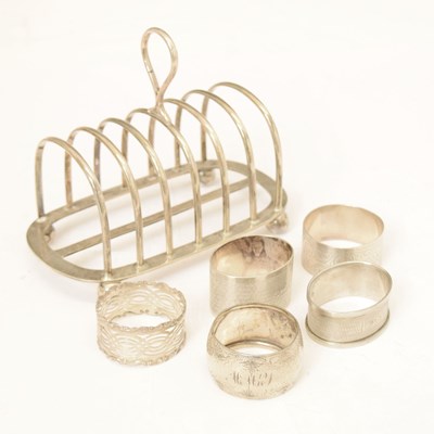 Lot 238 - George V silver toast rack, together with five silver napkin rings