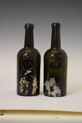Lot 42 - Two early 19th century dark green glass Utility bottles
