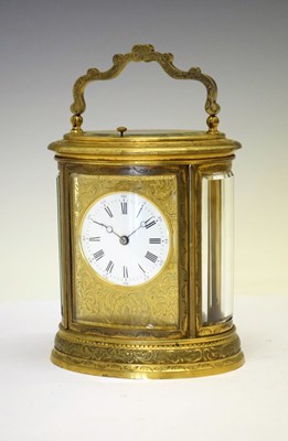 Lot 487 - Oval engraved brass-cased repeater carriage clock