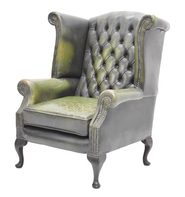 Lot 822 - Button back green leather armchair