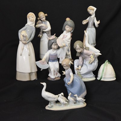 Lot 616 - Lladro - Seven porcelain figures and Christmas bell