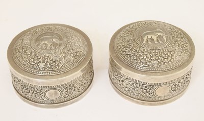 Lot 291 - Pair of Indian white-metal circular boxes with typical foliate and elephant kutch decoration