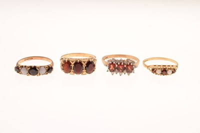 Lot 75 - Four assorted 9ct gold garnet set dress rings