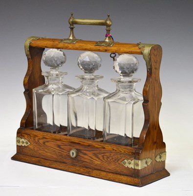 Lot 335 - Early 20th century oak three-bottle tantalus