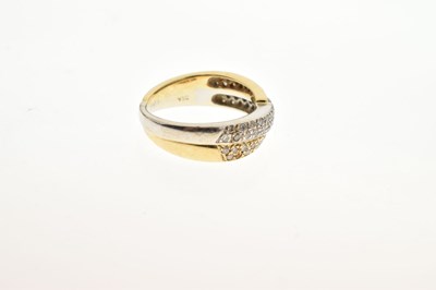 Lot 4 - 18ct two-colour gold diamond set crossover dress ring