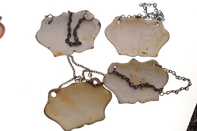Lot 298 - Collection of seventeen mid 18th century and later enamel wine and spirit decanter labels