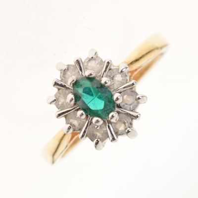 Lot 3 - Dress ring set green oval cut centre stone within a border of white stones