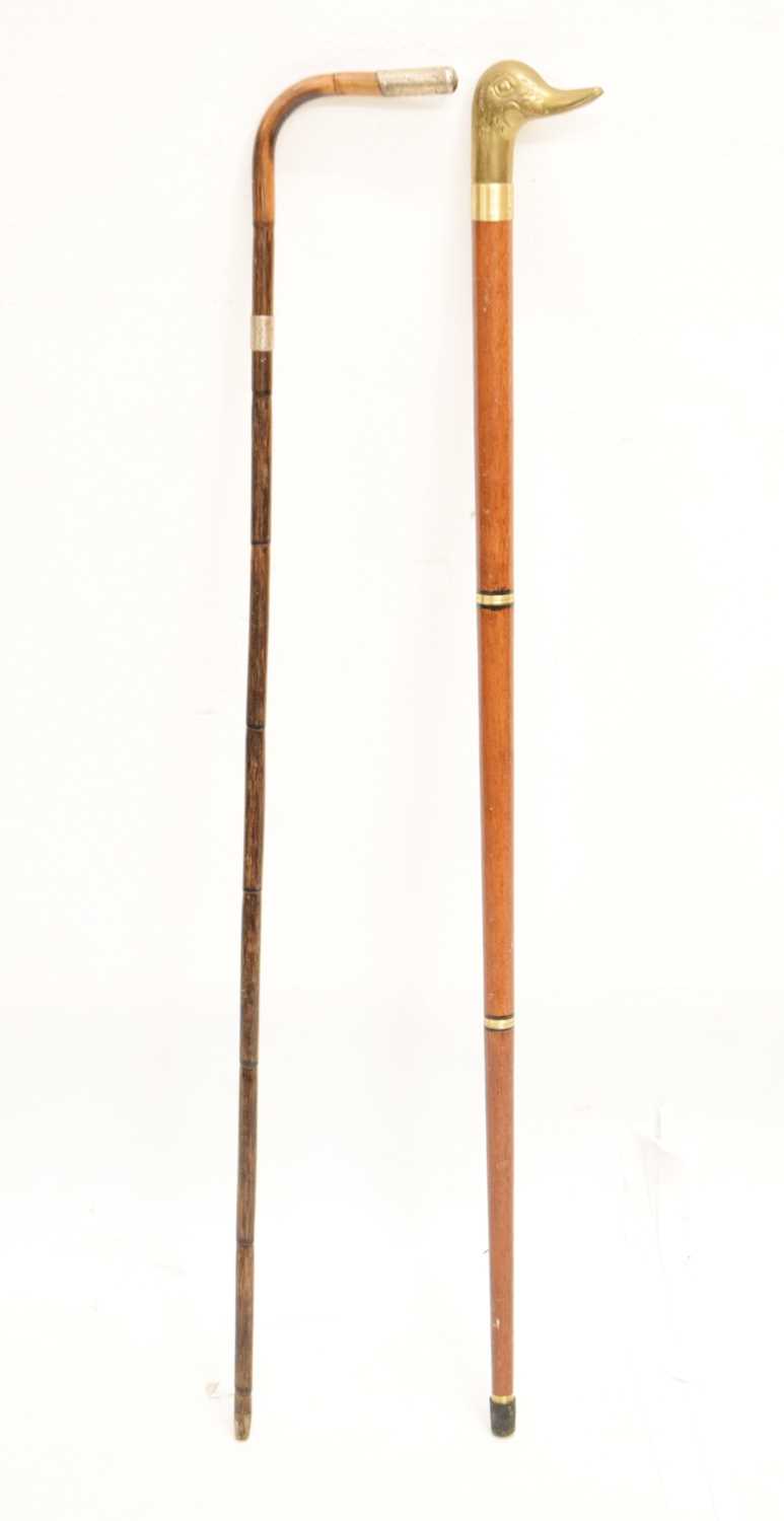 Lot 328 - Reproduction duck 'toper' walking stick and an early 20th century cane