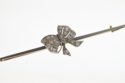 Lot 47 - '15c Pt' bar brooch having a diamond set bow