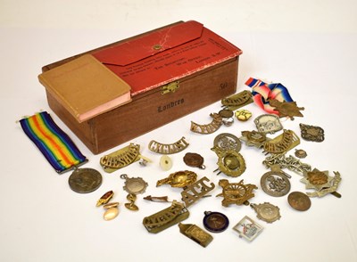 Lot 513 - Second World War medal pair and cap/uniform badges