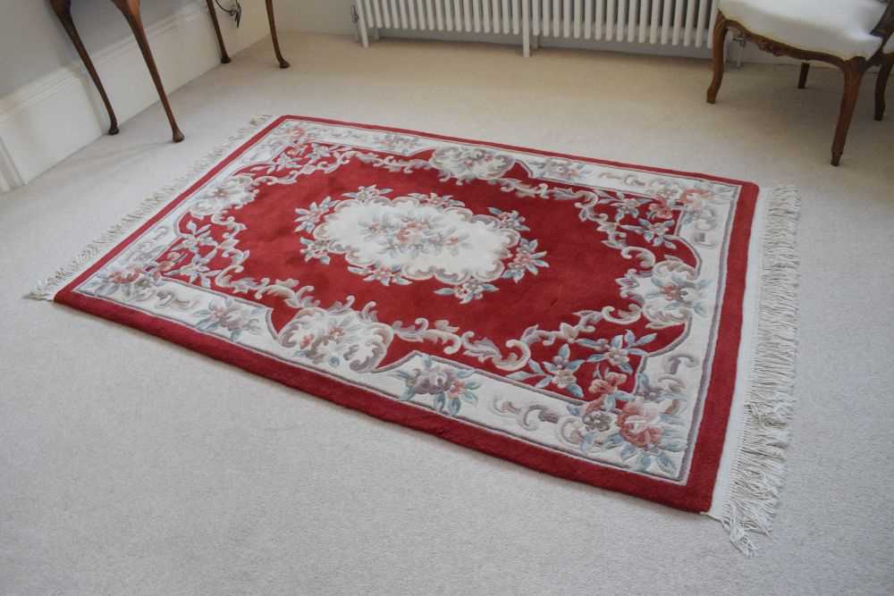 Lot 526 - Chinese claret ground wool rug