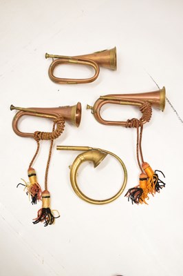 Lot 494 - Three copper and brass military bugles