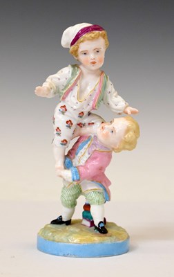 Lot 443 - Early 20th century porcelain figure group of two children playing