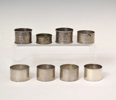 Lot 165 - Set of four Edward VII silver napkin rings, and four other silver napkin rings