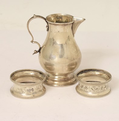 Lot 150 - Victorian silver sparrow beak cream jug, and a pair of George V silver napkin rings