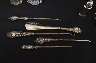 Lot 143 - Quantity of silver capped dressing requisites, silver handled button hooks, etc