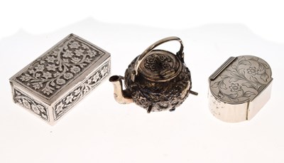 Lot 184 - Two foliate decorated silver boxes and a Chinese white metal miniature kettle