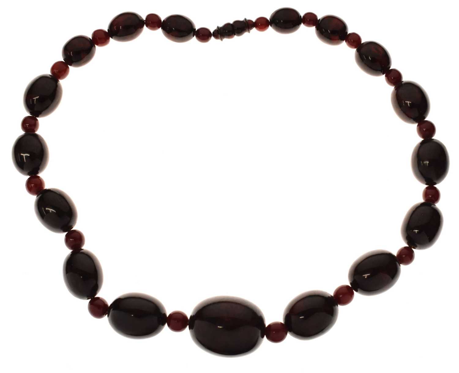 Lot 51 - 'Cherry amber' coloured bead necklace