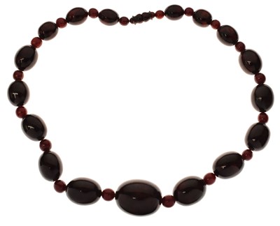 Lot 51 - 'Cherry amber' coloured bead necklace