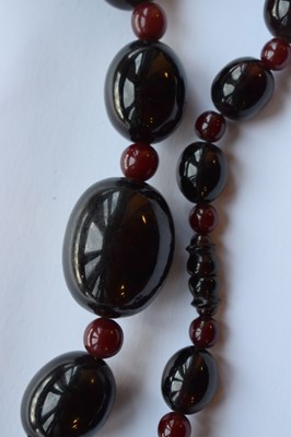 Lot 51 - 'Cherry amber' coloured bead necklace