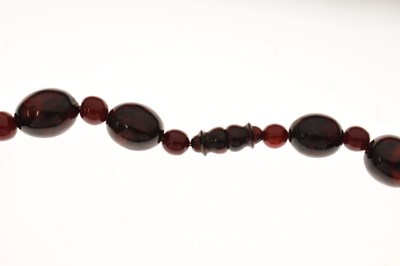 Lot 51 - 'Cherry amber' coloured bead necklace