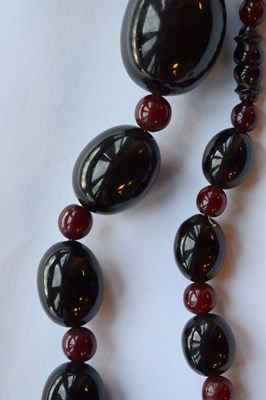 Lot 51 - 'Cherry amber' coloured bead necklace