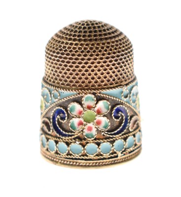 Lot 90 - Russian white metal thimble with an enamel band of floral decoration