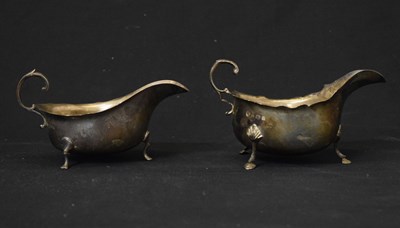 Lot 143 - Two silver sauceboats with scroll handles