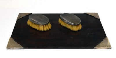 Lot 118 - Pair of Edward VII silver-mounted oval brushes and a white-metal mounted desk blotte