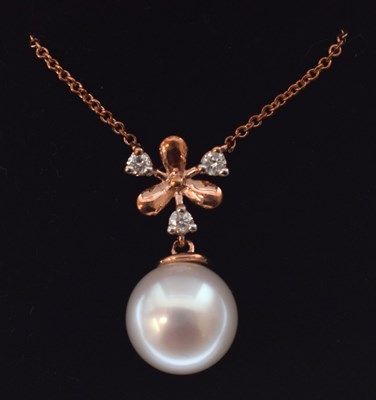 Lot 54 - 9ct rose gold, diamond and pearl 'snowflake' pendant with chain