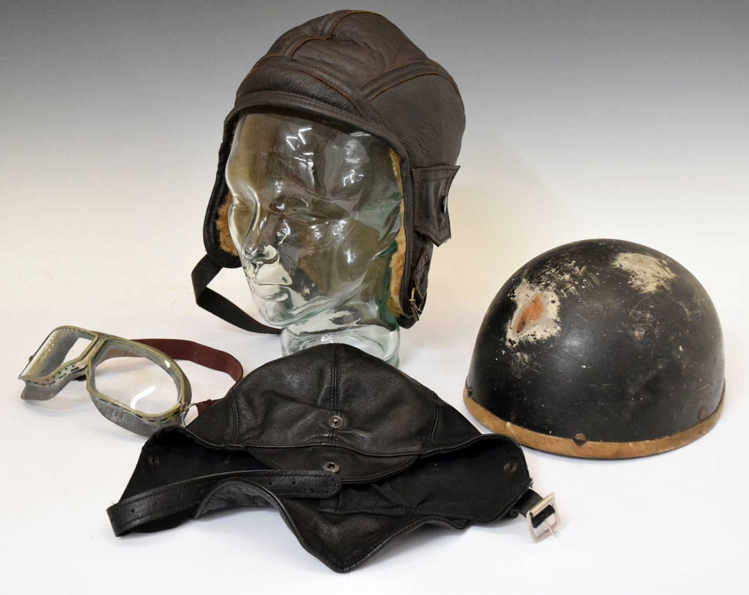 Lot 224 - Wooden motorcycle helmet and leather caps