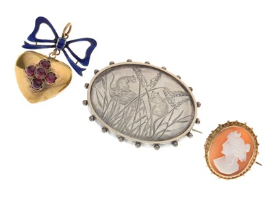 Lot 68 - Heart-shaped pendant set four red cabochons and having a blue enamel ribbon surmount